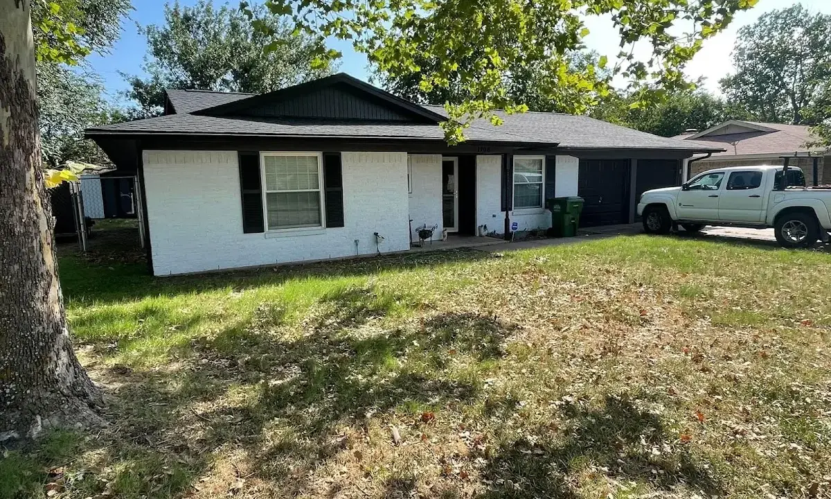 Professional roofing crew working on a residential roof in The Woodlands